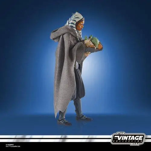 Vintage Collection Deluxe Ahsoka Tano & Grogu Action Figures - man in gray coat holding green bag