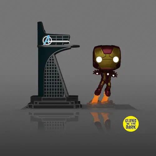 Iron Man Funko Pop figure with glow features next to Avengers Tower, Previews Exclusive